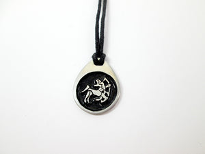 Sagittarius pendant necklace on black cord, teardrop pendant with black background, for man or woman. (picture taken on a white background)