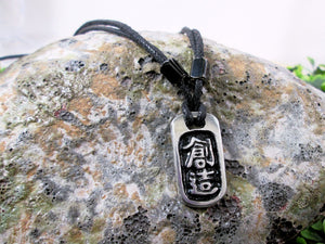 Kanji symbol for Creativity pendant with black background, black cord necklace style.